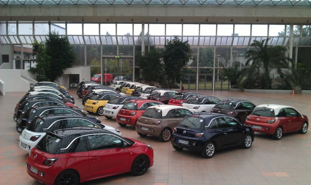 cars lined up in an atrium at a dealer launch