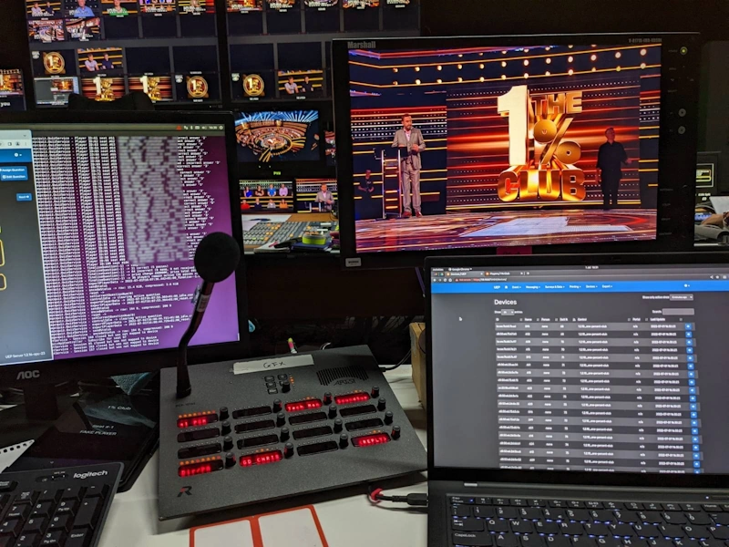 Laptops and screens behind the scenes at a TV Studio