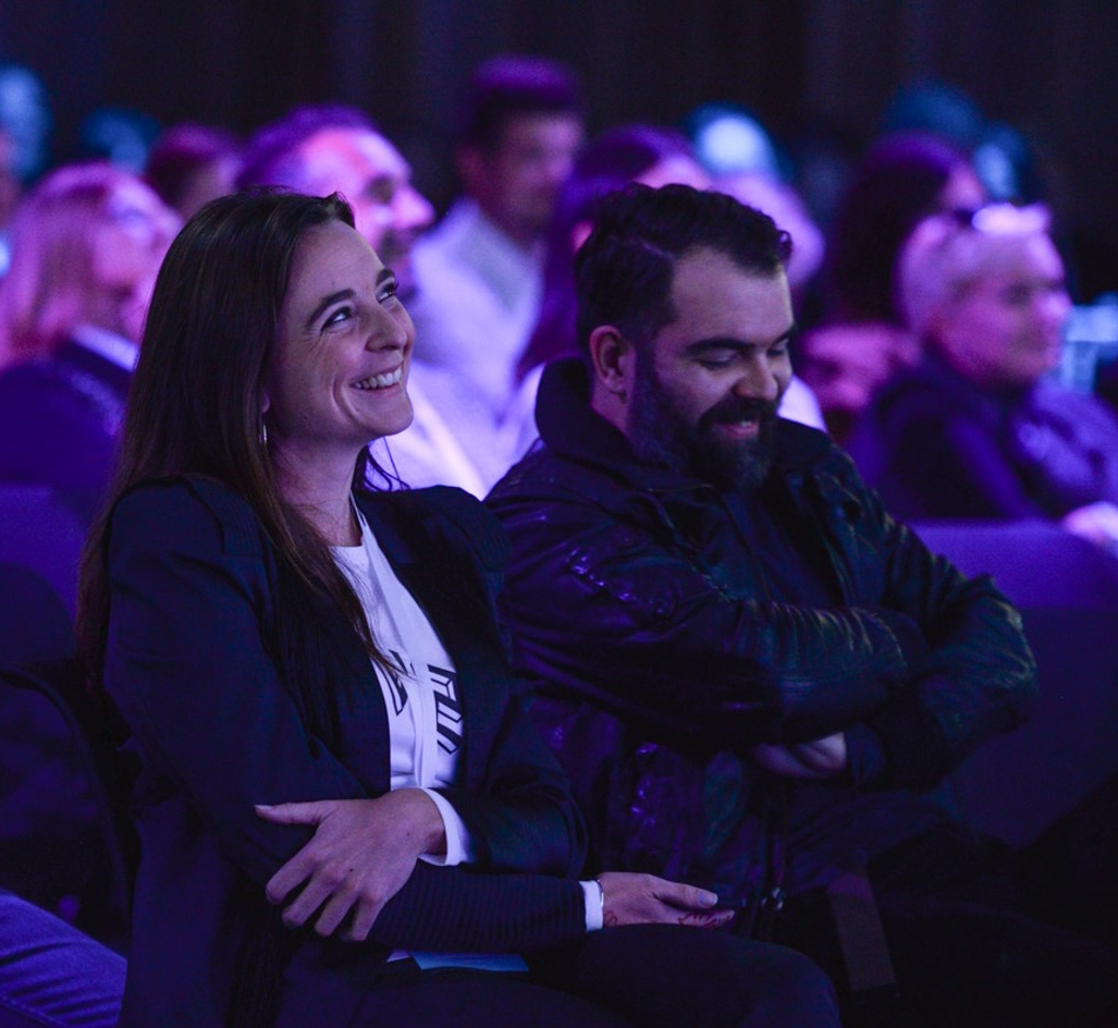 audience members smiling during a presentation